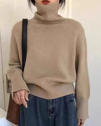 A thick cashmere turtleneck sweater with turtleneck, thick knit and loose fit, designed for a cozy winter layering look that pairs from sneakers to boots.