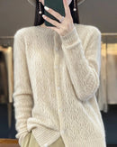 A thick 100% merino wool button-front cardigan with a round O-neck and relaxed fit, designed for poised warmth that layers easily from commute to dinner.