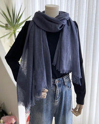 A lightweight gauze scarf shawl with a sheer weave and long cut, designed for airy sun shading and versatile layering from beach to travel.