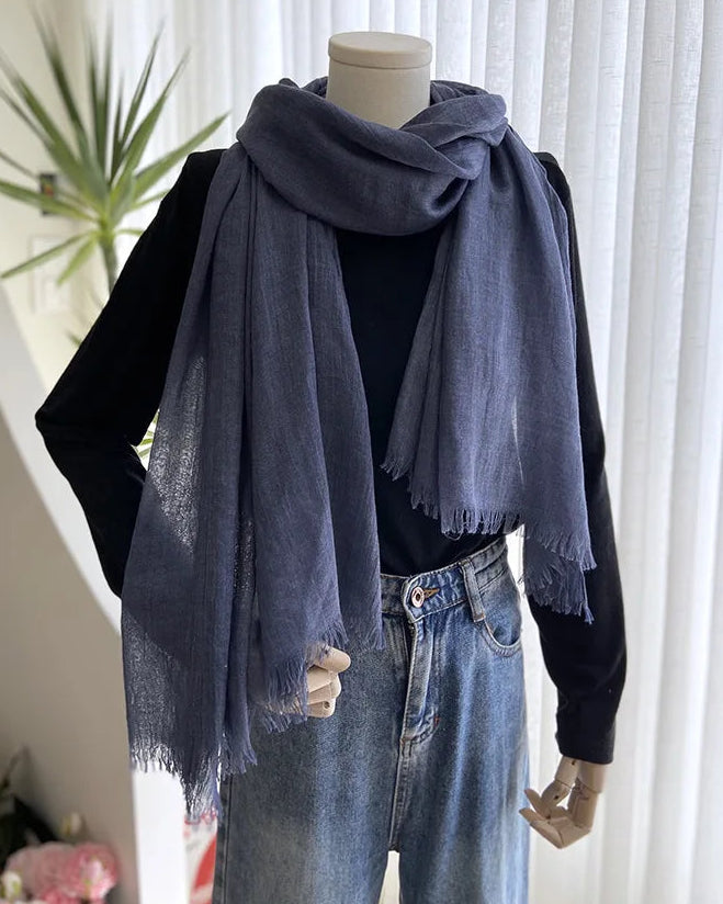 A lightweight gauze scarf shawl with a sheer weave and long cut, designed for airy sun shading and versatile layering from beach to travel.