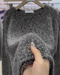 Dark grey marled wool crewneck sweater with a relaxed loose fit and long sleeves, featuring heathered yarn texture and classic round neckline styled for effortless autumn and winter layering.