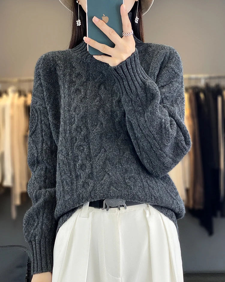 A turtleneck sweater crafted from extrafine merino wool with a twisted geometric knit and loose fit, designed for soft, warm layering.