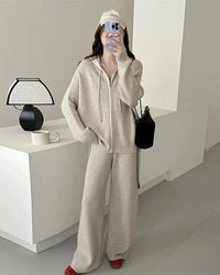A two-piece merino wool hooded knit set with a full-zip top and high-waist wide-leg trousers, designed for soft skin-friendly warmth from commute to dinner.