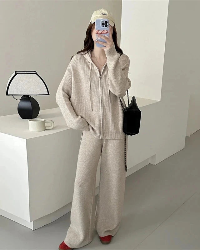 A two-piece merino wool hooded knit set with a full-zip top and high-waist wide-leg trousers, designed for soft skin-friendly warmth from commute to dinner.
