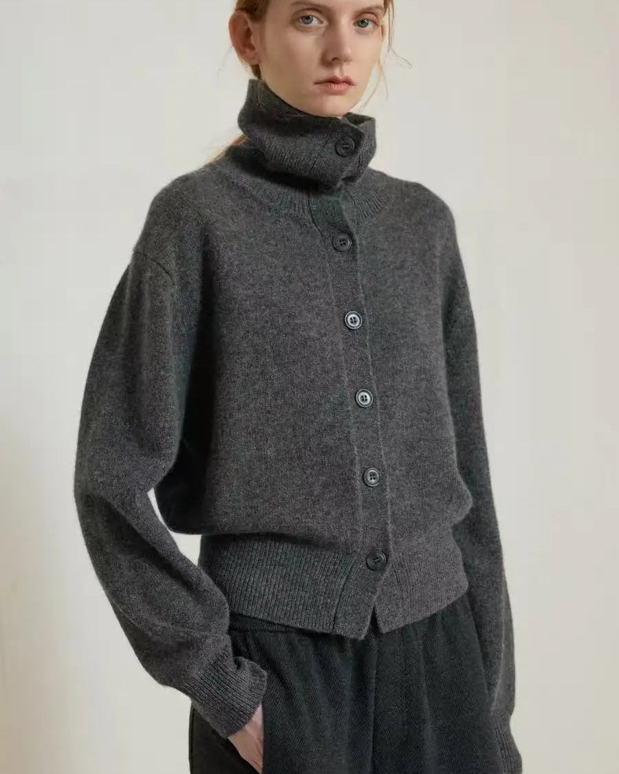 A heavyweight single-breasted cashmere turtleneck cardigan with turtleneck collar, single-breasted button front and loose fit, designed for a cozy winter layering look that pairs from sneakers to boots.