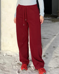 Women's high-waisted wide-leg sweatpants made from breathable cotton blend, featuring a climate-regulating fabric and elastic waist for spring and autumn comfort.
