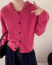 A single-breasted cashmere hooded cardigan with hooded neckline, single-breasted front and loose fit, designed for a cozy winter layering look that pairs from sneakers to boots.