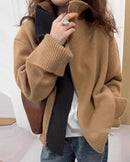 A long-sleeve cashmere cardigan featuring a sculpted turtleneck, a full-length front zipper, and an oversized knit for a cozy, relaxed silhouette.