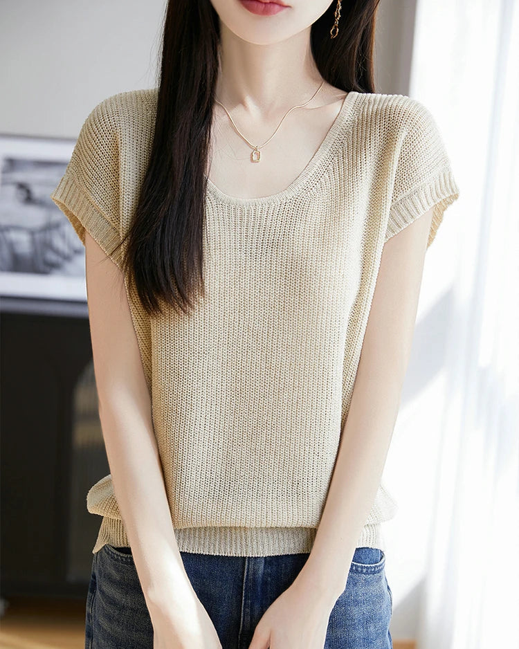 Women's crew-neck sleeveless knit top featuring a linen-lyocell blend, breathable fabric, and an elongated silhouette for minimalist layering in the city.