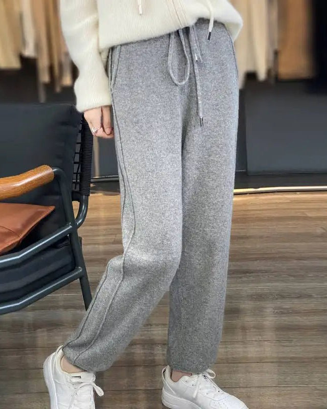 Woman heading to work in High-Waist Drawstring Wool Knitted Pants, 90 % wool / 10 % cashmere rib drapes like jersey—your polished yet cozy 45-65 °F fall-to-spring commuter layer.