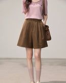 Women's brown high-waisted A-line straight leg shorts, featuring a fluid polyester-viscose blend and front pleats for polished ease from morning commute to weekend street style.