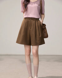 Women's brown high-waisted A-line straight leg shorts, featuring a fluid polyester-viscose blend and front pleats for polished ease from morning commute to weekend street style.