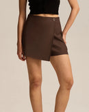 Women's asymmetric A-line mini skort featuring breathable polyester-nylon blend, an elastic waist, and button detail for modern summer office wear.