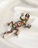 Colorful crystal lizard brooch in gold tone, trendy reptile pin with vibrant multicolor gemstones and detailed body, perfect for adding playful sparkle.