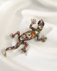Colorful crystal lizard brooch in gold tone, trendy reptile pin with vibrant multicolor gemstones and detailed body, perfect for adding playful sparkle.