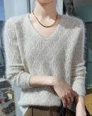 A mink cashmere v-neck sweater with v-neck, openwork detail, loose fit, long sleeves and stretch, designed for a cozy winter layering look that pairs from sneakers to boots.
