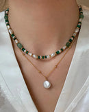 A beaded necklace featuring round freshwater pearls and natural jade beads on 14K gold-filled findings, designed for a classic, elegant look.