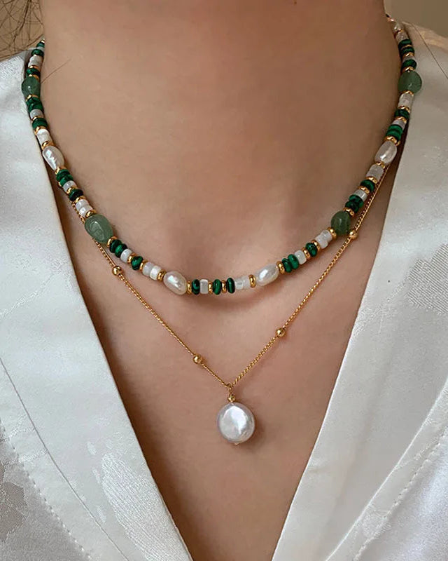 A beaded necklace featuring round freshwater pearls and natural jade beads on 14K gold-filled findings, designed for a classic, elegant look.