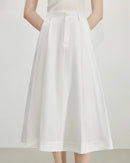 French high waist A-line midi skirt in pure cotton. Empire waist, hidden pockets, adjustable fit — refined minimalism for everyday elegance.