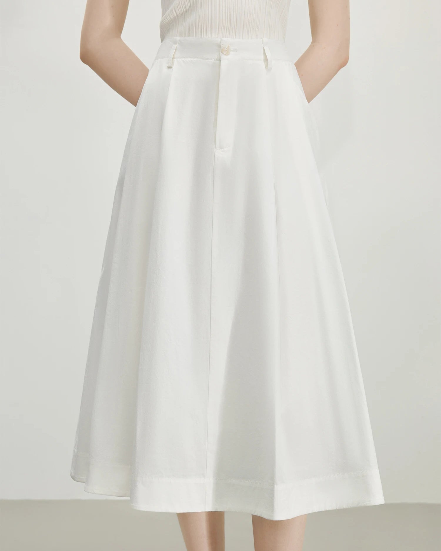French high waist A-line midi skirt in pure cotton. Empire waist, hidden pockets, adjustable fit — refined minimalism for everyday elegance.