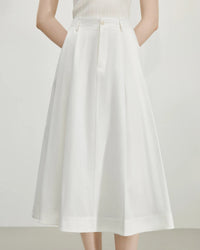 French high waist A-line midi skirt in pure cotton. Empire waist, hidden pockets, adjustable fit — refined minimalism for everyday elegance.