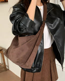 A large faux suede casual tote with secure zipper, adjustable strap and inner zipper pocket, designed for versatile everyday styling from day to evening.