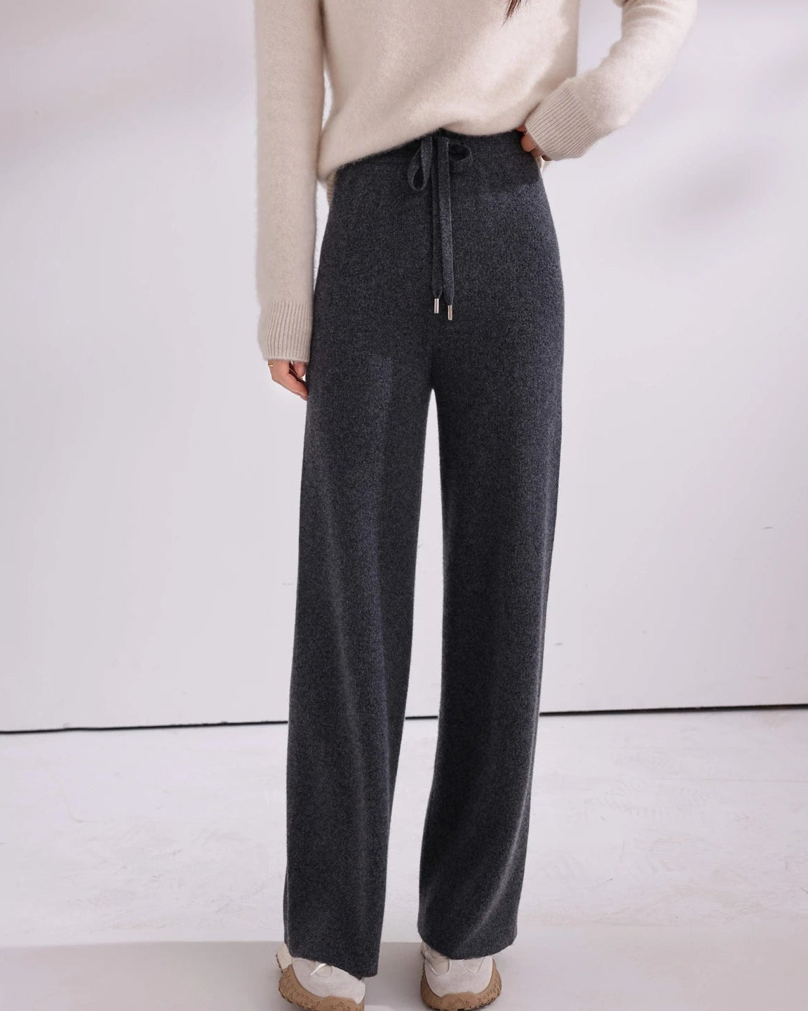 A drawstring fastening adjusts at the waist, while the full length cut lends a polished line. Enjoy the gentle give of knit construction.