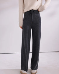 A drawstring fastening adjusts at the waist, while the full length cut lends a polished line. Enjoy the gentle give of knit construction.