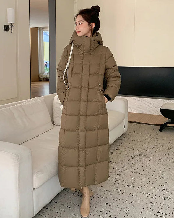 A refined approach to everyday outerwear, this long puffer coat balances sculptural quilting with a streamlined silhouette.