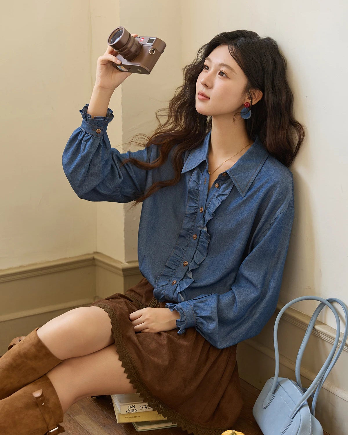 Women's blue ruffled placket denim shirt, featuring lyocell imitation-denim and a cinched waist for soft, breathable elegance from office desk to weekend brunch.