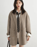 A wool-blend double-breasted midi overcoat featuring a turn-down collar, side pockets, and a relaxed fit for elegant autumn-winter wear.