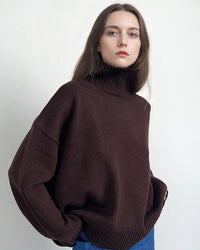 An oversized heavyweight knit pullover featuring a turtleneck, a relaxed silhouette, and a straight sleeve for effortless layered warmth.