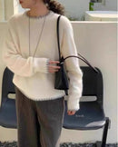 Tonal blocking that reads as sophisticated rather than bold. Knitted in a fine yarn at heavyweight density.