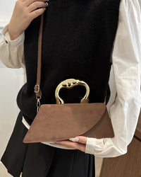 A minimalist PU leather square shoulder bag with metal hand-held detail, crossbody strap and polyester lining, designed for a modern versatile look from day to evening.