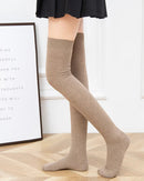 Ribbed wool over-knee stockings. Natural fiber warmth, soft knit texture, elegant thigh-high silhouette. Perfect for autumn styling. 