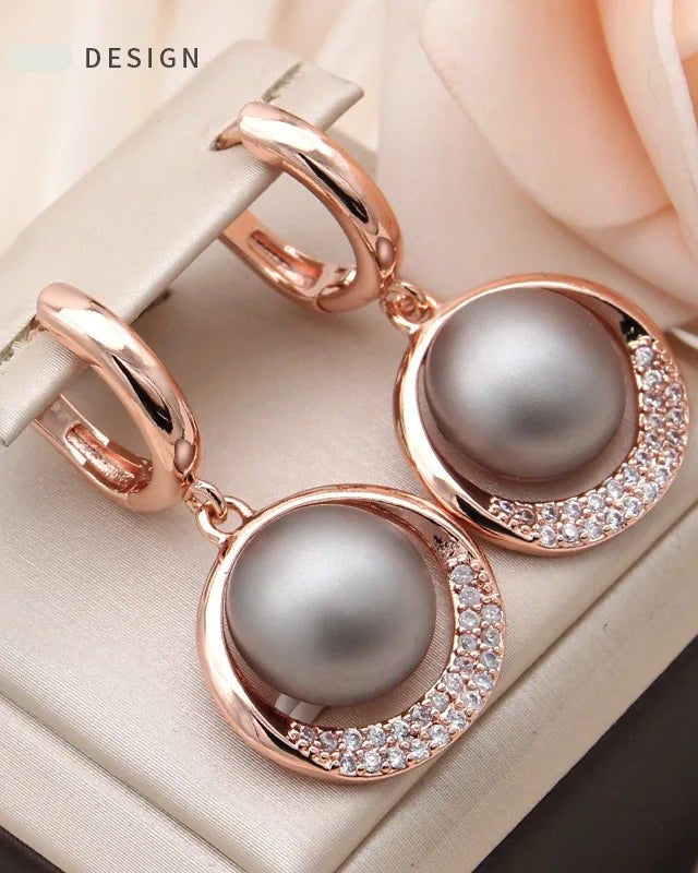 Thoughtfully proportioned and delicately finished, these simulated pearl drop earrings move gracefully with the wearer.