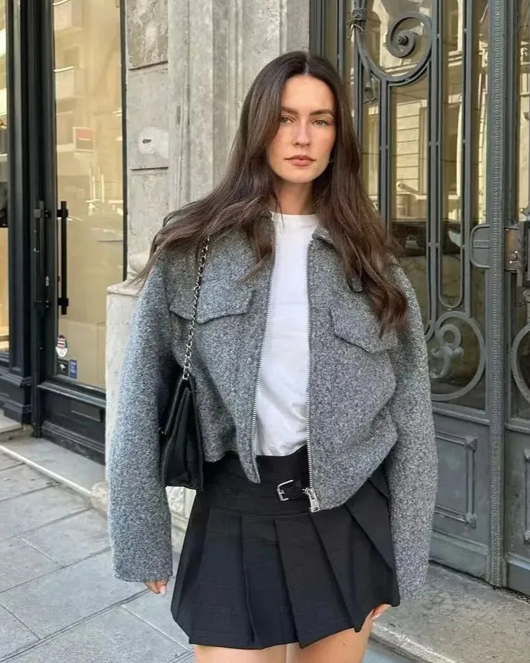 Gray vintage-style cropped woolen jacket featuring a turn-down collar, front zipper closure, and two functional chest pockets. short, wide-waisted coat is made from a textured polyester fabric, offering a chic and cozy layer for autumn and winter.