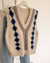 A sleeveless knit sweater vest featuring a deep V-neck with contrast trim and a gingham pattern, offering a relaxed fit for effortless layering.