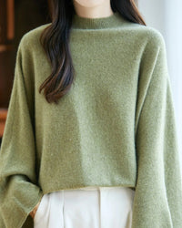 Wide sleeves create an expressive silhouette, while the ribbed mock neckline keeps the look considered and clean.