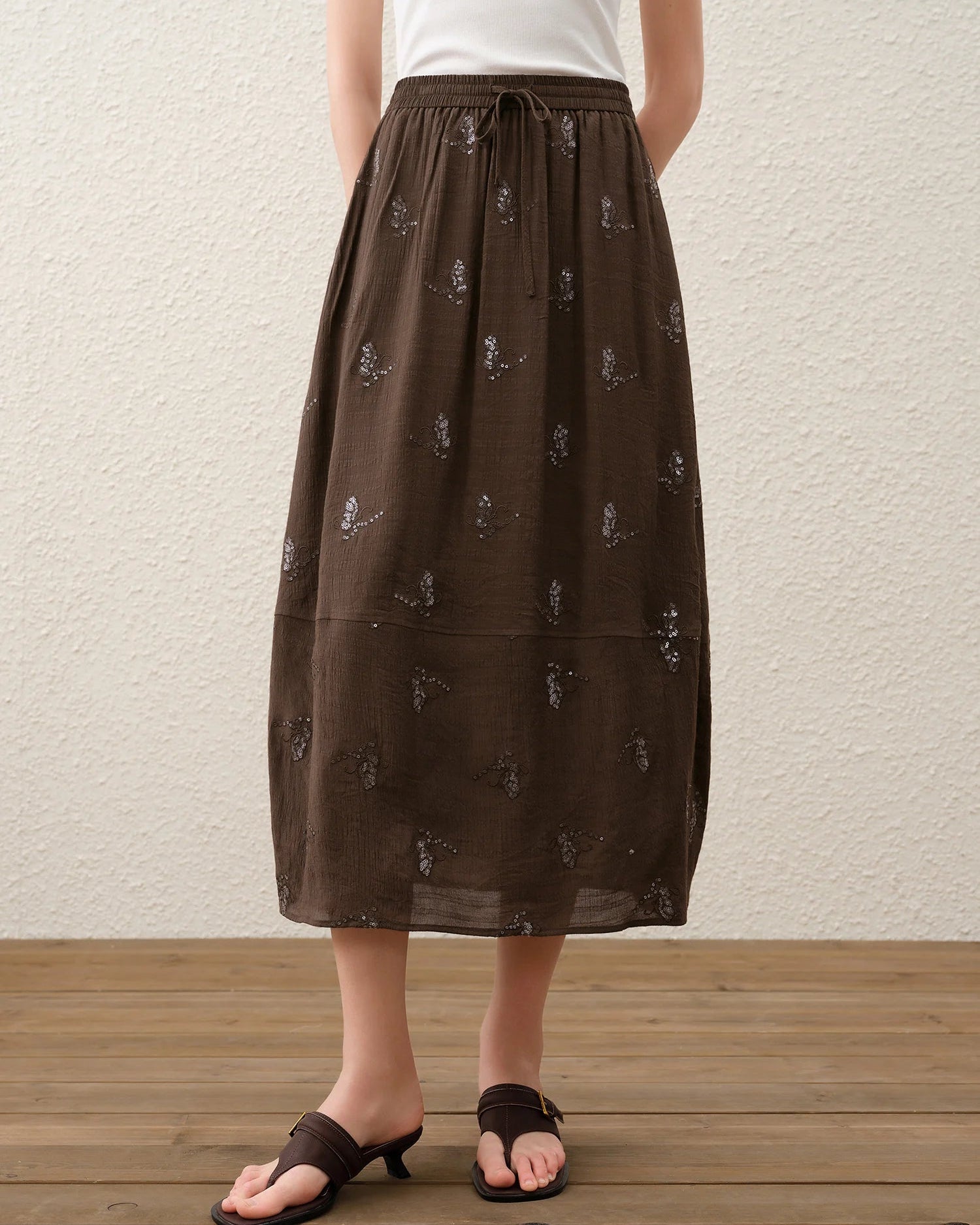 Women's  Embroidered Tulip midi skirt crafted from breathable linen-blend fabric, featuring a tulip-cut silhouette and elastic waistband for refined summer femininity.