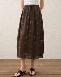 Women's  Embroidered Tulip midi skirt crafted from breathable linen-blend fabric, featuring a tulip-cut silhouette and elastic waistband for refined summer femininity.
