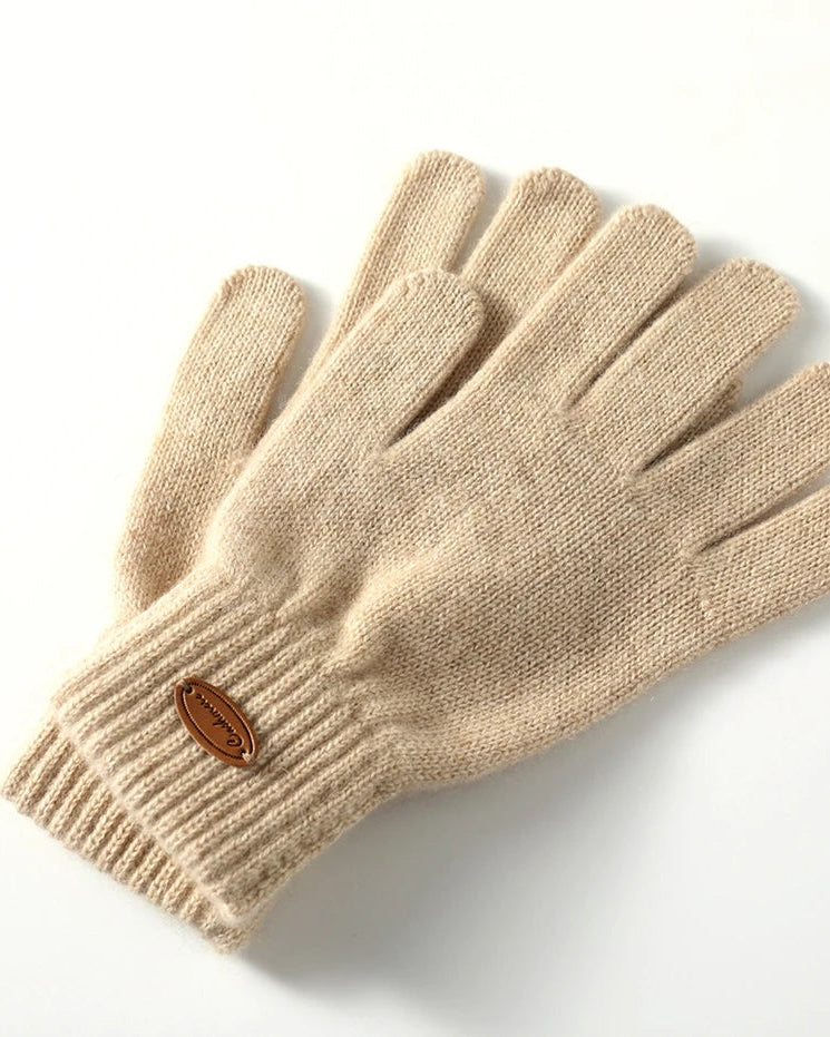 Pure cashmere knit gloves with an extended cuff and full-finger coverage. Thick-gauge construction for exceptional warmth and refined cold-weather style.