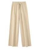 Merino wool wide-leg trousers featuring a lace-up mid-seam detail, an elastic waist, and a seamless knit for a soft, elegant silhouette.
