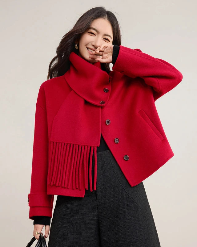 A wool coat featuring a detachable fringed scarf collar, drop shoulders, and welt pockets, designed for a versatile, warm winter look.