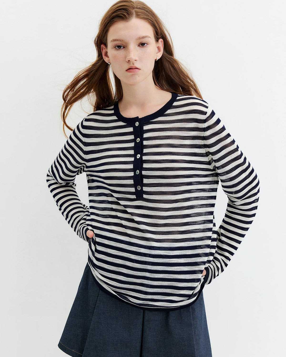 A lightweight striped knit top in a soft rayon blend with a round neck and button placket, designed for a relaxed, versatile look.