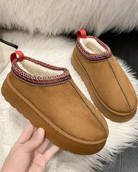 These slip-on winter booties redefine casual warmth. A plush fleece collar frames the opening, while the dense shearling insole provides cushioned support underfoot. 