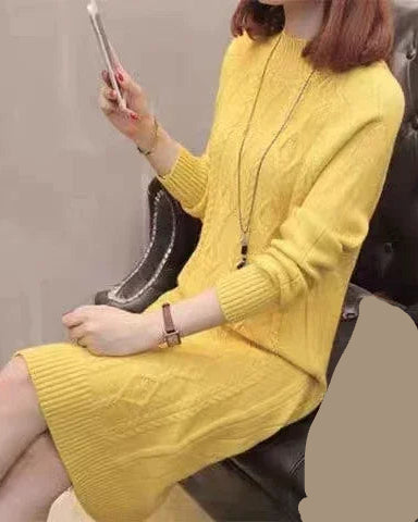 A thick mock-neck ribbed knit midi dress featuring a relaxed H-line silhouette and raglan sleeves for deep warmth and a comfortable fit.