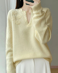 A floral-embroidered wool sweater with v-neck, floral embroidery, loose fit, long sleeves and stretch, designed for a cozy winter layering look that pairs from sneakers to boots.