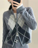 A argyle merino wool zip cardigan with mock neck, zip front, argyle diamonds, cable-knit sleeves, regular fit, long sleeves and stretch, designed for a cozy winter layering look that pairs from sneakers to boots.