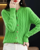 A 100% mink cashmere cable knit cardigan with a round neck and button front, designed for soft anti-pilling warmth that layers easily over tees.